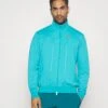 Nike Performance Heritage - Training Jacket - Teal 1 Nike Performance Heritage - Training Jacket - Teal -Clothing Category Store 98149e1d031246e0bfd9ed0f145741c9